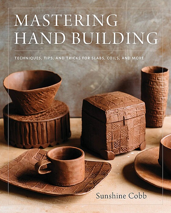 Cover of the book "Mastering Hand Building" by Sunshine Cobb. The cover features various handmade pottery items, including bowls, cups, a lidded box, and a tray, all made from a brown clay material. Text on the cover highlights techniques, tips, and tricks.