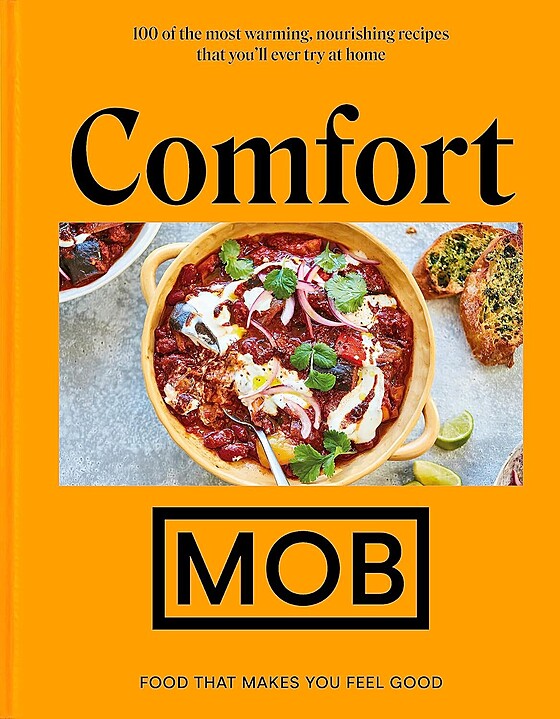Cover of the cookbook "comfort mob: food that makes you feel good" featuring a photo of a bowl of comforting food with tomato sauce, cheese, and herbs, surrounded by slices of garlic bread.