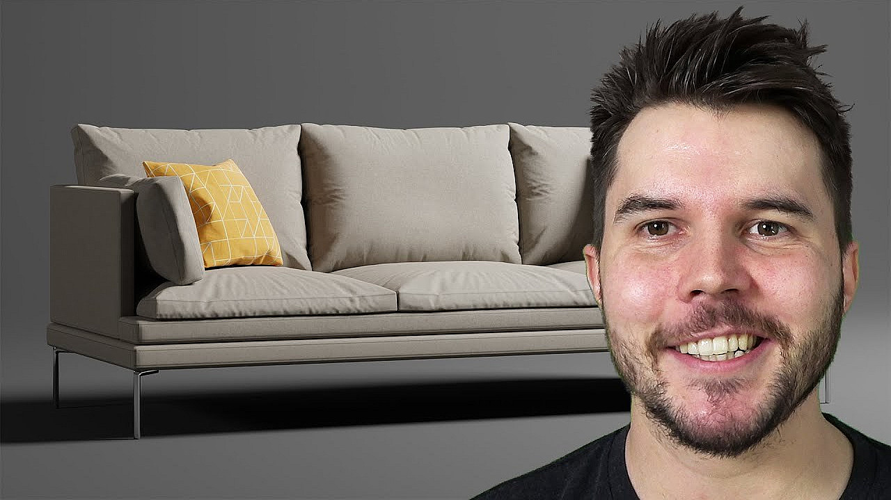 A man with short dark hair and a beard is smiling. Behind him, there is a modern beige sofa with a yellow and white patterned throw pillow on the left side, set against a dark gray background.