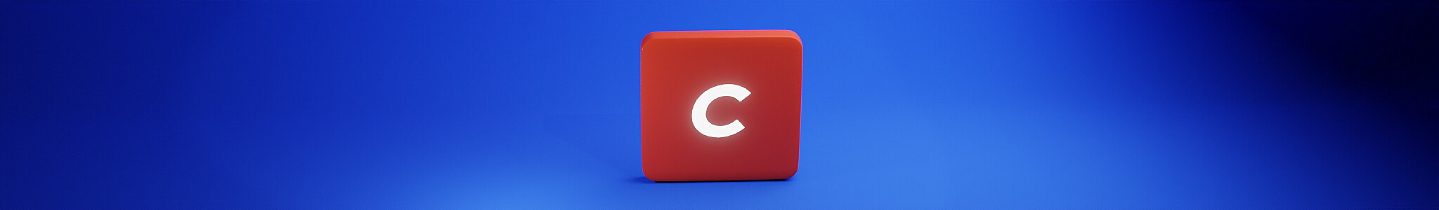 A red cube with a white letter 'C' on one side is centered against a blue gradient background. The lighting creates a soft shadow effect around the cube.